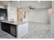 Open kitchen layout with an island, stainless steel appliances, modern lighting, and tile flooring at 4866 N 185Th Dr, Goodyear, AZ 85395