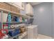 Well-organized laundry room with washer, dryer, and ample storage shelving at 4866 N 185Th Dr, Goodyear, AZ 85395