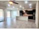 Bright and open living area seamlessly connected to the modern kitchen and a large kitchen island at 4866 N 185Th Dr, Goodyear, AZ 85395