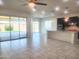 Open-concept living area with tile flooring, bar seating and access to a bright and spacious kitchen at 4866 N 185Th Dr, Goodyear, AZ 85395