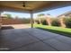 Covered patio with fan overlooking lush landscaping and privacy fence at 4866 N 185Th Dr, Goodyear, AZ 85395