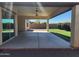 This covered patio includes recessed lights and a ceiling fan at 4866 N 185Th Dr, Goodyear, AZ 85395