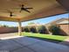 This outdoor covered patio has recessed lighting, a ceiling fan, and artificial grass at 4866 N 185Th Dr, Goodyear, AZ 85395