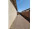 A side yard with gravel landscaping and privacy fencing between neighboring homes in the community at 4866 N 185Th Dr, Goodyear, AZ 85395