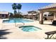 Community pool and spa with lounge chairs and covered patio at 9311 E Kiowa Ave, Mesa, AZ 85209