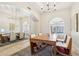 Elegant dining area with large windows, a beautiful chandelier, and a mirrored wall at 9623 W Tierra Grande --, Peoria, AZ 85383