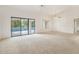 Bright living room with sliding doors that lead to the backyard pool at 18402 N 137Th Dr, Sun City West, AZ 85375