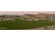 Peaceful community park with homes and walking path at sunset at 21576 E Pecan Ct, Queen Creek, AZ 85142