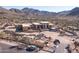 Aerial view of a large, modern home under construction in a mountainous desert setting at 22805 N Church Rd, Scottsdale, AZ 85255