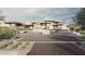Modern home with a long driveway and landscaped desert landscaping at 22805 N Church Rd, Scottsdale, AZ 85255