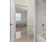Bathroom view with white tile shower and bedroom visible in the background at 2578 N Acacia Way, Buckeye, AZ 85396