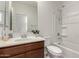 Bathroom featuring a vanity with a mirror, and a shower-tub combo at 2578 N Acacia Way, Buckeye, AZ 85396