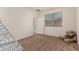 Inviting carpeted bedroom with natural light, a door, and neutral wall paint at 2578 N Acacia Way, Buckeye, AZ 85396