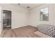 Comfortable bedroom with carpet floors and a window offering natural light at 2578 N Acacia Way, Buckeye, AZ 85396