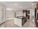 Stylish kitchen with a center island, stainless steel appliances, and an open layout that connects to the living area at 2578 N Acacia Way, Buckeye, AZ 85396