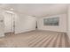 Spacious living room with carpet floors and large window, perfect for entertaining and relaxation at 2578 N Acacia Way, Buckeye, AZ 85396