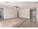 Open-concept living area with neutral tones, tile flooring, and seamless flow to other rooms in the home at 2578 N Acacia Way, Buckeye, AZ 85396