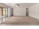 Bright open living space with tile floors and sliding doors to the backyard, creating an airy and inviting atmosphere at 2578 N Acacia Way, Buckeye, AZ 85396