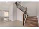 Inviting foyer showcasing a staircase with decorative iron balusters and a glimpse of the adjacent living space at 2578 N Acacia Way, Buckeye, AZ 85396
