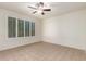 Bright bedroom with tile floors, ceiling fan and window shutters at 3872 N Hawthorn Dr, Florence, AZ 85132