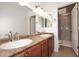 Bright bathroom featuring a double vanity with granite countertops and a glass enclosed shower at 5122 E Shea Blvd # 1117, Scottsdale, AZ 85254