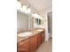 Bathroom featuring double vanity, modern mirrors, and a glass door shower at 5122 E Shea Blvd # 1117, Scottsdale, AZ 85254