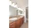 Bright bathroom featuring a double vanity with granite countertops and a glass enclosed shower at 5122 E Shea Blvd # 1117, Scottsdale, AZ 85254