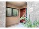 Inviting front entrance features a red door, textured walls, and lush greenery at 5122 E Shea Blvd # 1117, Scottsdale, AZ 85254