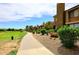 Beautiful pathway near the golf course with well-maintained landscaping and lush green grass at 5122 E Shea Blvd # 1117, Scottsdale, AZ 85254