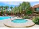 Inviting hot tub near the main pool, lounge chairs, and mature landscaping at 5122 E Shea Blvd # 1117, Scottsdale, AZ 85254