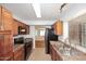 Well-equipped kitchen with wooden cabinets, black appliances, and tile floors offering style and functionality at 5122 E Shea Blvd # 1117, Scottsdale, AZ 85254