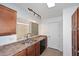 Kitchen featuring a stainless steel sink, brown cabinets, and a window view at 5122 E Shea Blvd # 1117, Scottsdale, AZ 85254