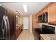Kitchen with stainless steel appliances, wood cabinets, and granite countertops at 5122 E Shea Blvd # 1117, Scottsdale, AZ 85254