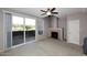Carpeted living room featuring a fireplace, ceiling fan, and sliding glass door at 5122 E Shea Blvd # 1117, Scottsdale, AZ 85254