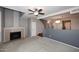 Spacious carpeted living room with fireplace and stairs to the second floor at 5122 E Shea Blvd # 1117, Scottsdale, AZ 85254