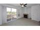 Cozy living room featuring a fireplace, carpet, sliding glass doors, and ceiling fan at 5122 E Shea Blvd # 1117, Scottsdale, AZ 85254