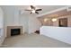 Open-concept living room showcasing a fireplace, ceiling fan, and seamless flow to the dining area at 5122 E Shea Blvd # 1117, Scottsdale, AZ 85254