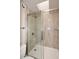 Modern glass enclosed shower stall with a white shower pan and stone pattern surround at 5122 E Shea Blvd # 1117, Scottsdale, AZ 85254