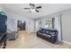 Bright living room with black leather couch and view of adjacent room at 5515 W Sunnyside Dr, Glendale, AZ 85304