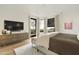 Inviting main bedroom features hardwood floors, a neutral color scheme, a media center, and large windows at 5630 E Rockridge Rd, Phoenix, AZ 85018