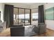 This main bedroom has a sitting area with views of the backyard, an outdoor dining set, pool, and desert landscape at 5630 E Rockridge Rd, Phoenix, AZ 85018