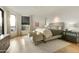 A cozy main bedroom features hardwood floors, a neutral color palette, large windows and an adjacent sitting area at 5630 E Rockridge Rd, Phoenix, AZ 85018