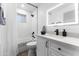 Modern bathroom with white vanity, quartz countertop and illuminated mirror at 5835 E Dodge St, Mesa, AZ 85205