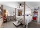 Spacious bedroom with a large wooden canopy bed and ample storage at 5835 E Dodge St, Mesa, AZ 85205