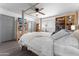 Bright bedroom featuring a comfortable bed, built-in shelving, and a ceiling fan at 5835 E Dodge St, Mesa, AZ 85205