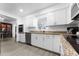 Updated kitchen featuring granite countertops and white cabinets at 5835 E Dodge St, Mesa, AZ 85205