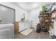Well-equipped laundry room with washer, dryer, and ample storage shelving at 5835 E Dodge St, Mesa, AZ 85205
