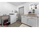 Laundry room features a utility sink, washer, dryer, and additional cabinets at 5835 E Dodge St, Mesa, AZ 85205