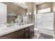 Well-appointed bathroom with double sinks, a large mirror, and a shower/tub combo at 9814 W Rowel Rd, Peoria, AZ 85383