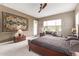 King bedroom with large wall hanging and sitting area at 9814 W Rowel Rd, Peoria, AZ 85383